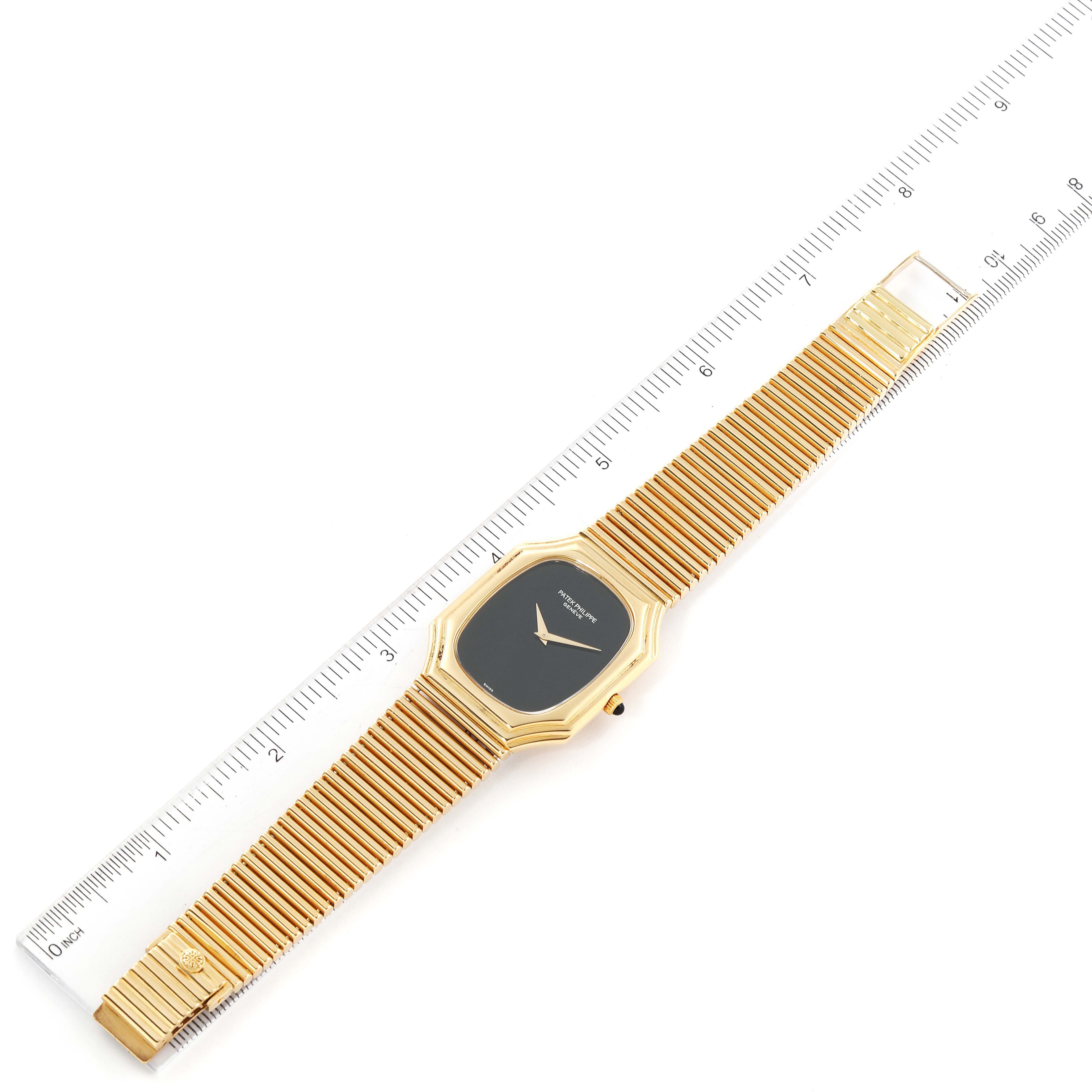 The image shows a gold Patek Philippe Vintage 3729/1 Men's Yellow Gold Black Dial 3729/1 Men's Yellow Gold Black Dial model watch with a black dial and mesh bracelet, positioned alongside a ruler for scale.