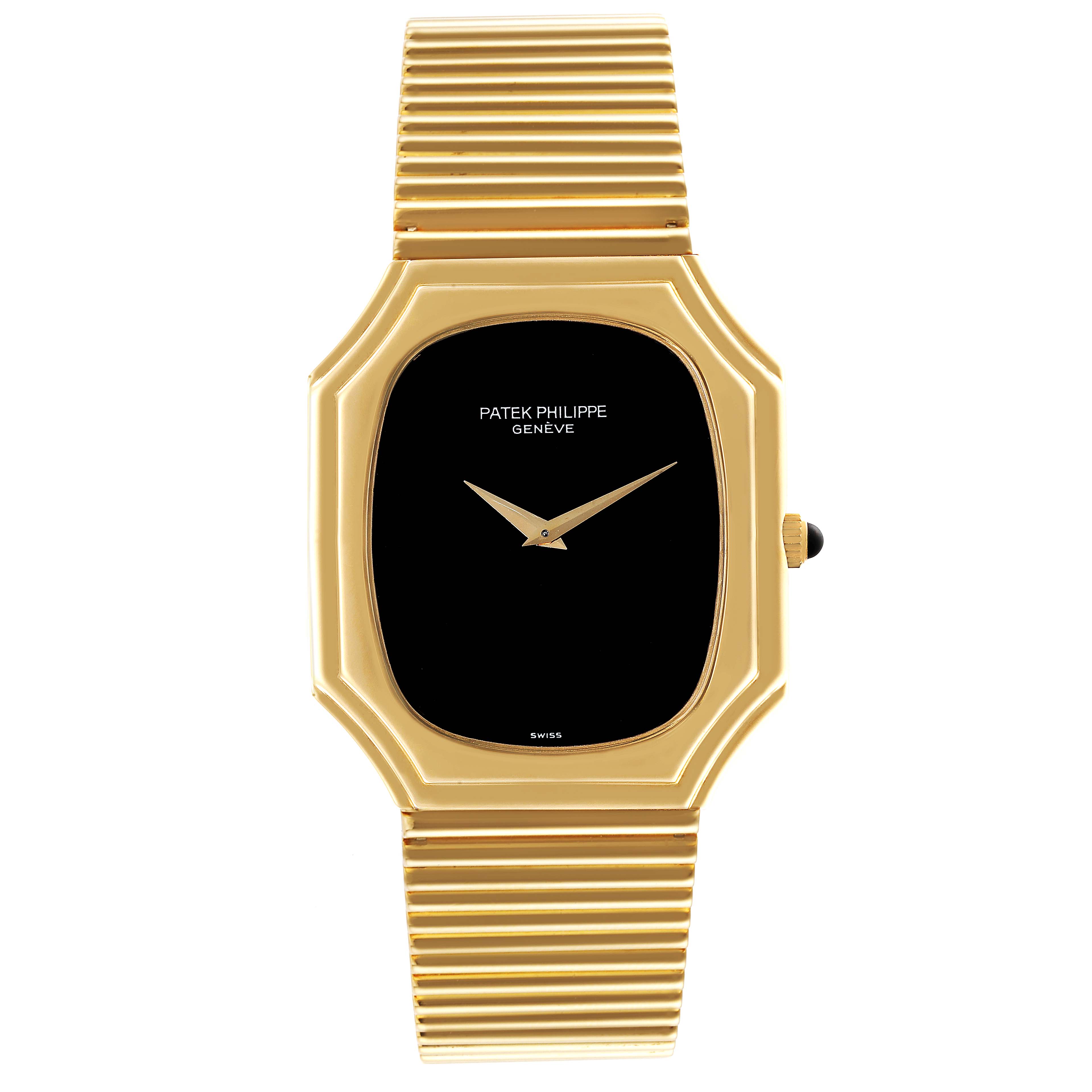 This image shows a straight-on view of a Vintage Patek Philippe watch, focusing on its black dial, gold rectangular case, and integrated bracelet.