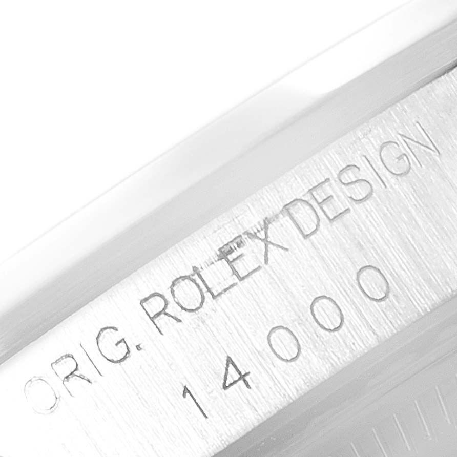 The image shows a close-up of the engraved "ORIG. ROLEX DESIGN" and model number 14000 on the Rolex Air-King 14000 Men's Stainless Steel Blue Dial 14000 Men's Stainless Steel Blue Dial watch case.