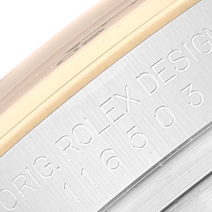 The image shows a close-up of the engraved edge and bezel of a Rolex Daytona 116503 Men's Steel and Gold (two tone) Champagne Dial 116503 Men's Steel and Gold (two tone) Champagne Dial watch.