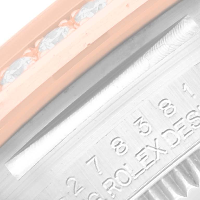 The image shows a close-up of the bezel with diamonds and the engraved side of the case for the Mid-Size Rolex watch.