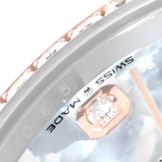 This image shows a close-up of the bezel, dial, and part of the hand of a Rolex Mid-Size 278381 Women
s Steel and Gold (two tone) Mother of Pearl Dial 278381 Women
s Steel and Gold (two tone) Mother of Pearl Dial model watch.