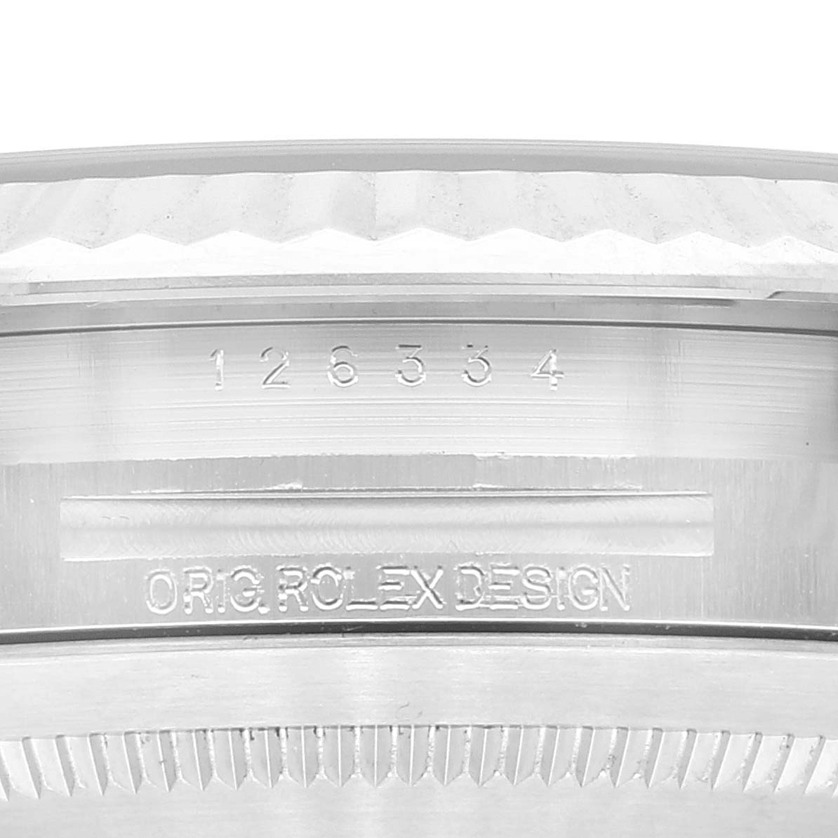 This close-up image shows the serial number and "ORIG ROLEX DESIGN" engraving on the bezel of a Rolex Datejust 41 126334 Men's Stainless Steel Silver Dial 126334 Men's Stainless Steel Silver Dial model.