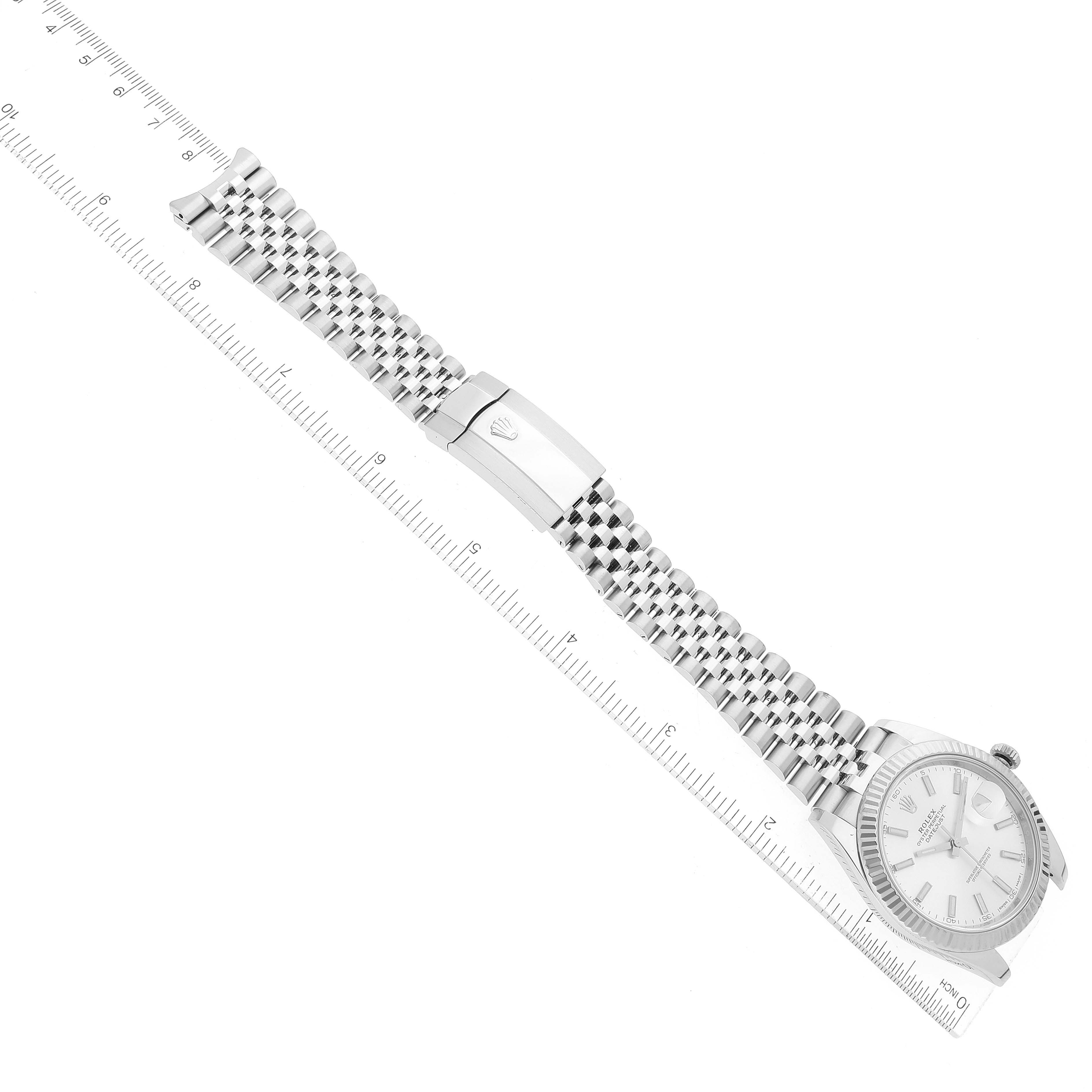 The image shows a top-down view of the Rolex Datejust 41 126334 Men's Stainless Steel Silver Dial 126334 Men's Stainless Steel Silver Dial watch, focusing on the face, clasp, and bracelet, with a ruler for scale.