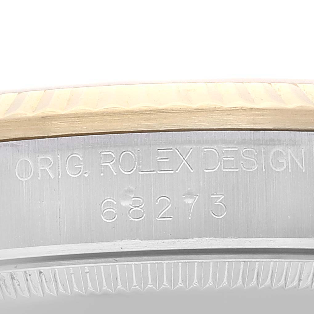 This close-up image shows the model number engraving on the side of the case of a Mid-Size Rolex watch.