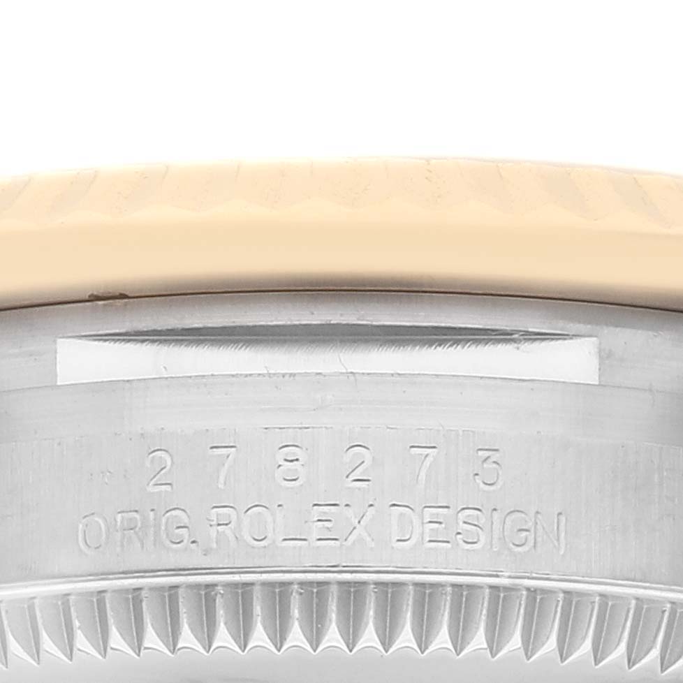 This image shows a close-up of the bezel and case edge with serial number engraving on the Mid-Size Rolex watch.