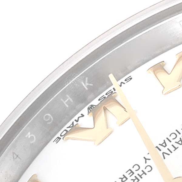 The image shows a close-up of the dial and part of the bezel of a Mid-Size Rolex watch, highlighting the hour markers and text.