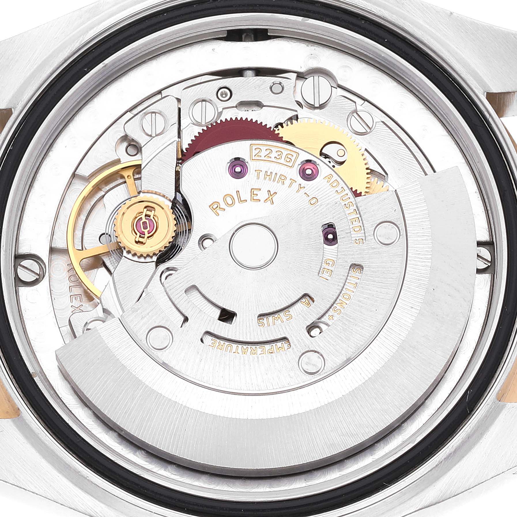 This image shows the movement mechanism from the backside of a Mid-Size Rolex watch, highlighting its intricate components.