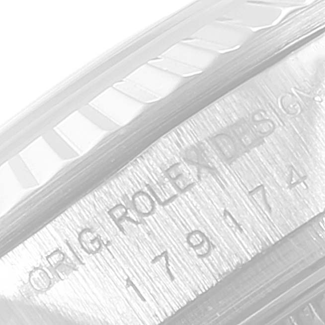 This close-up image features the fluted bezel and case engraving of a Rolex Datejust 179174 Women's Stainless Steel White Dial 179174 Women's Stainless Steel White Dial watch.