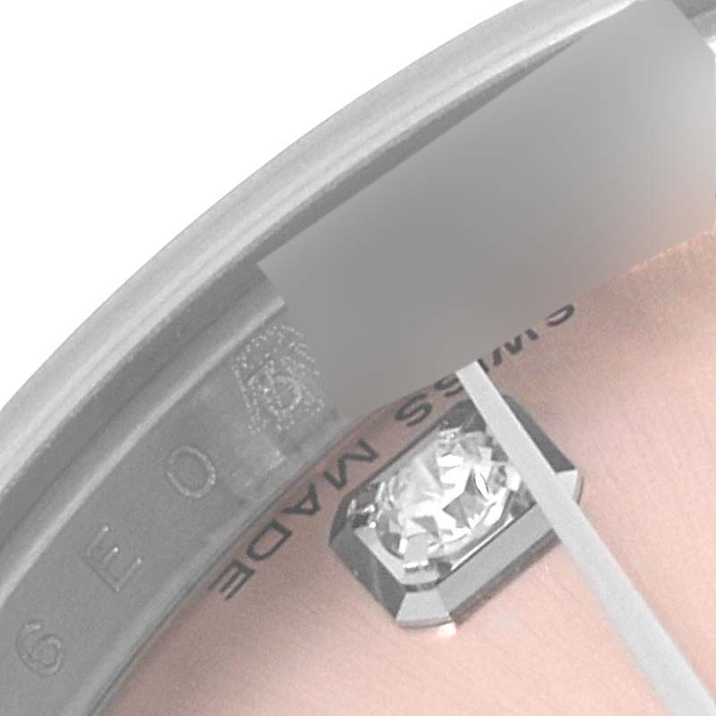 This is a close-up of the dial, bezel, and diamond marker on a Rolex Datejust 179174 Women's Stainless Steel Pink Dial 179174 Women's Stainless Steel Pink Dial watch.