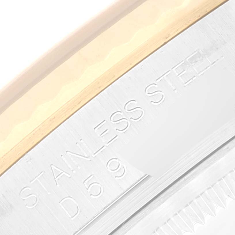 This close-up image of a Rolex Datejust 116233 Men's Steel and Gold (two tone) Blue Dial 116233 Men's Steel and Gold (two tone) Blue Dial watch shows the engraved "STAINLESS STEEL" marking and part of the bezel.