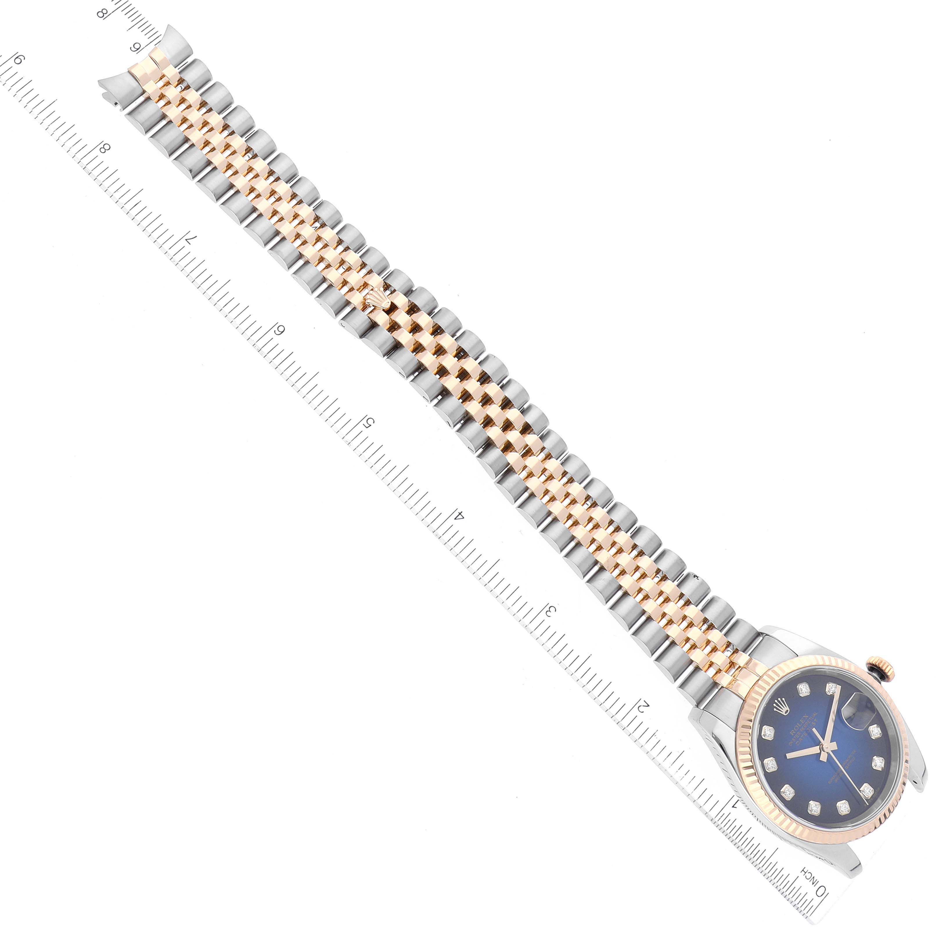 The image shows a Rolex Datejust 116233 Men's Steel and Gold (two tone) Blue Dial 116233 Men's Steel and Gold (two tone) Blue Dial watch with a Jubilee bracelet, viewed from a top-down angle with a ruler for scale.