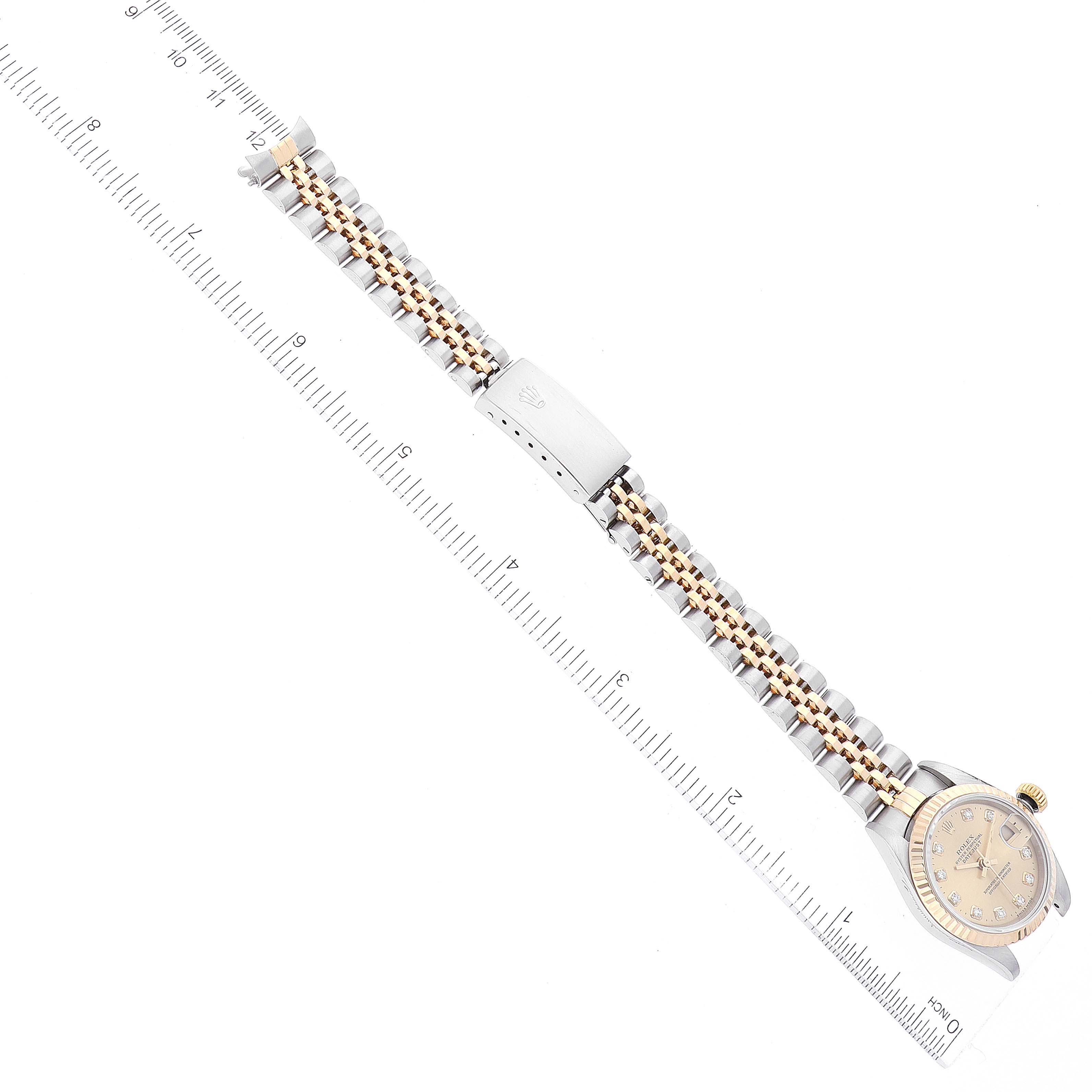 This image shows the Rolex Datejust 79173 Women's Steel and Gold (two tone) Champagne Dial 79173 Women's Steel and Gold (two tone) Champagne Dial watch laid flat, highlighting the face, bracelet, and clasp from a top-down angle.