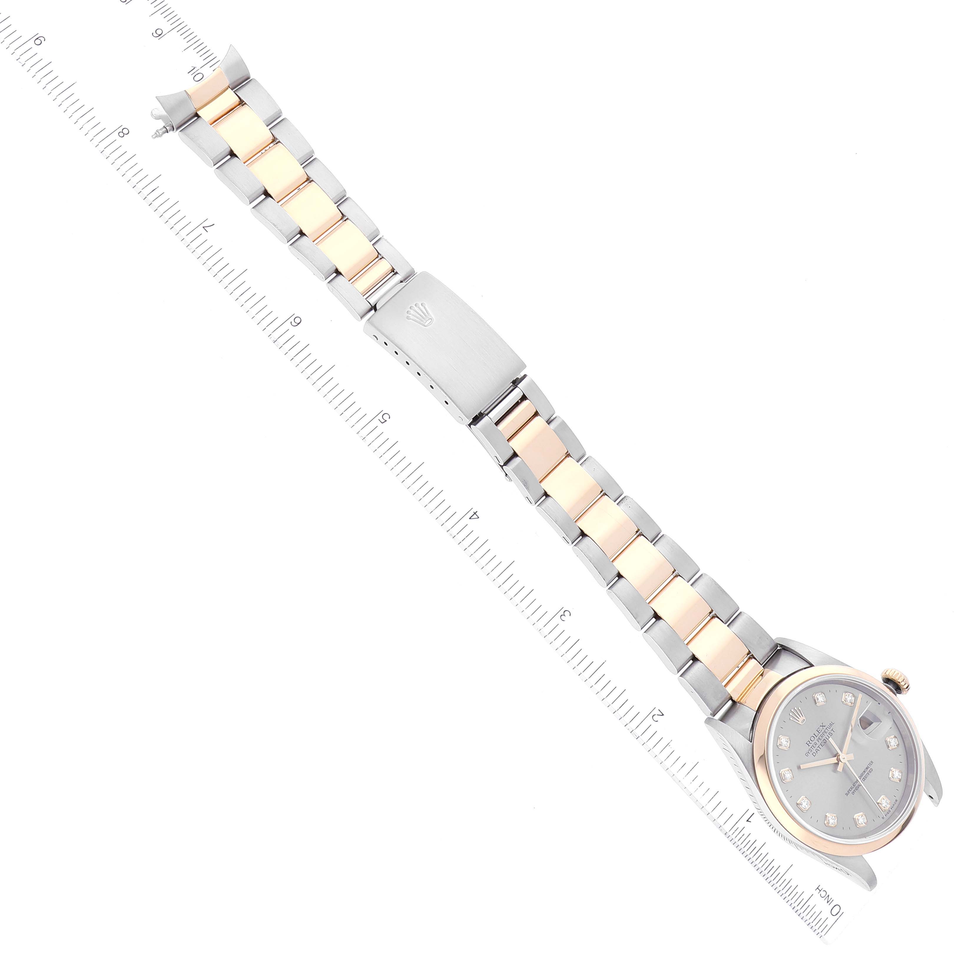 The image shows a Rolex Datejust 16203 Men's Steel and Gold (two tone) Grey Dial 16203 Men's Steel and Gold (two tone) Grey Dial watch with a bi-metal bracelet, displayed flat alongside a measuring ruler.