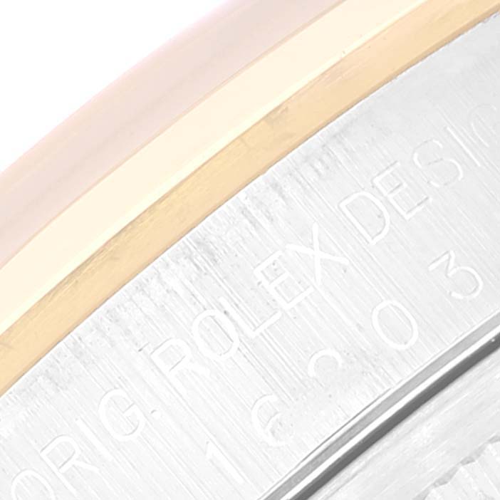 This close-up image shows the side view of the Rolex Datejust 16203 Men's Steel and Gold (two tone) Grey Dial 16203 Men's Steel and Gold (two tone) Grey Dial watch, highlighting the engraving and the edge of the bezel.