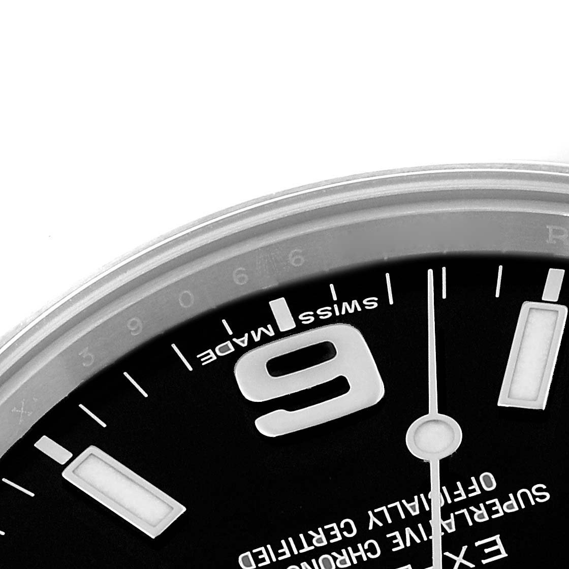 The image shows a close-up of the top left section of the dial on a Rolex Explorer 214270 Men
s Stainless Steel Black Dial 214270 Men
s Stainless Steel Black Dial watch, highlighting the "9" marker and "Swiss Made" text.