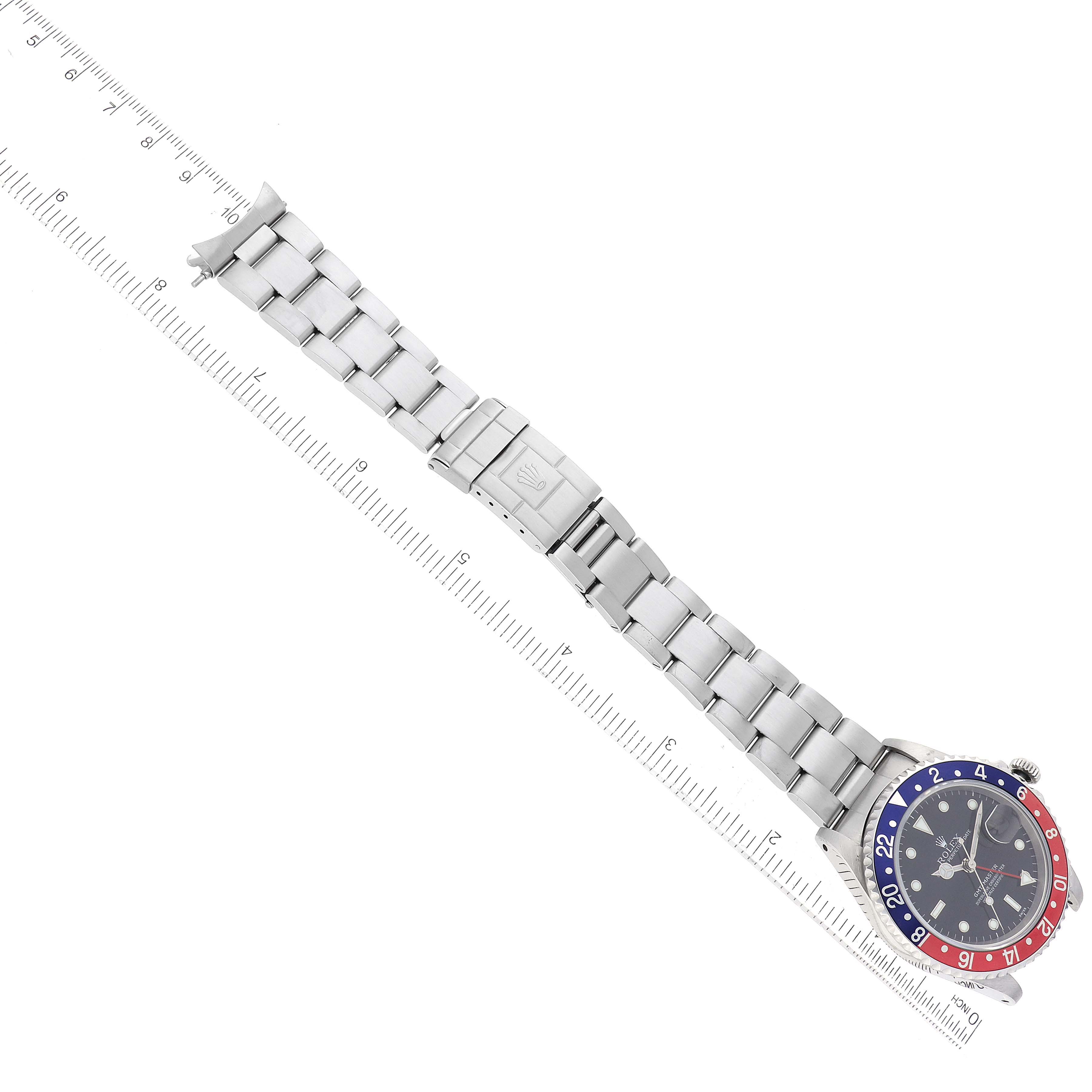 This GMT-Master Rolex watch is shown from a top-down angle, highlighting the face, bezel, band, and clasp.