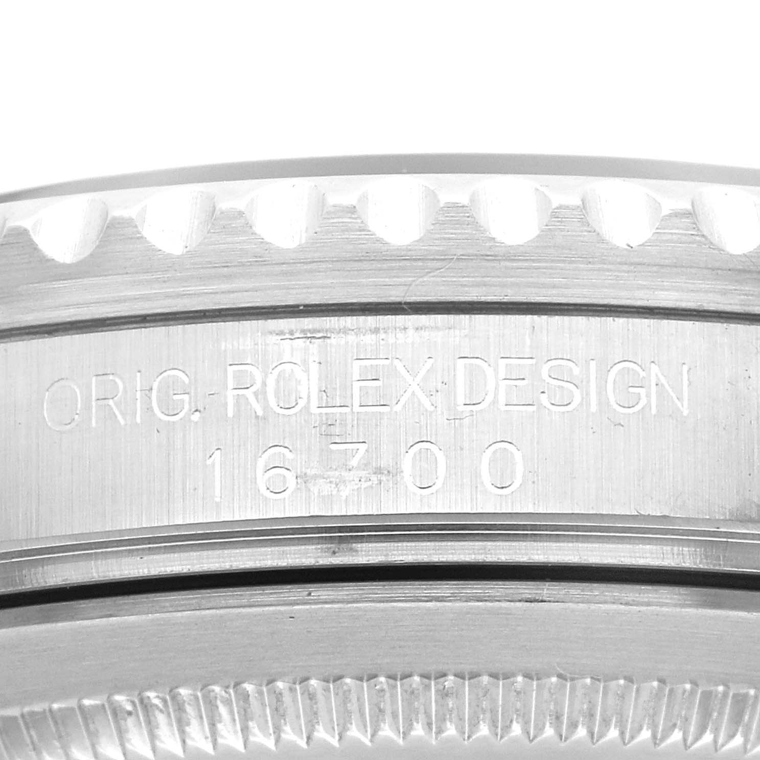 This image shows a close-up of the engraved case side of a Rolex GMT-Master 16700 Men's Stainless Steel Black Dial 16700 Men's Stainless Steel Black Dial watch model 16700.