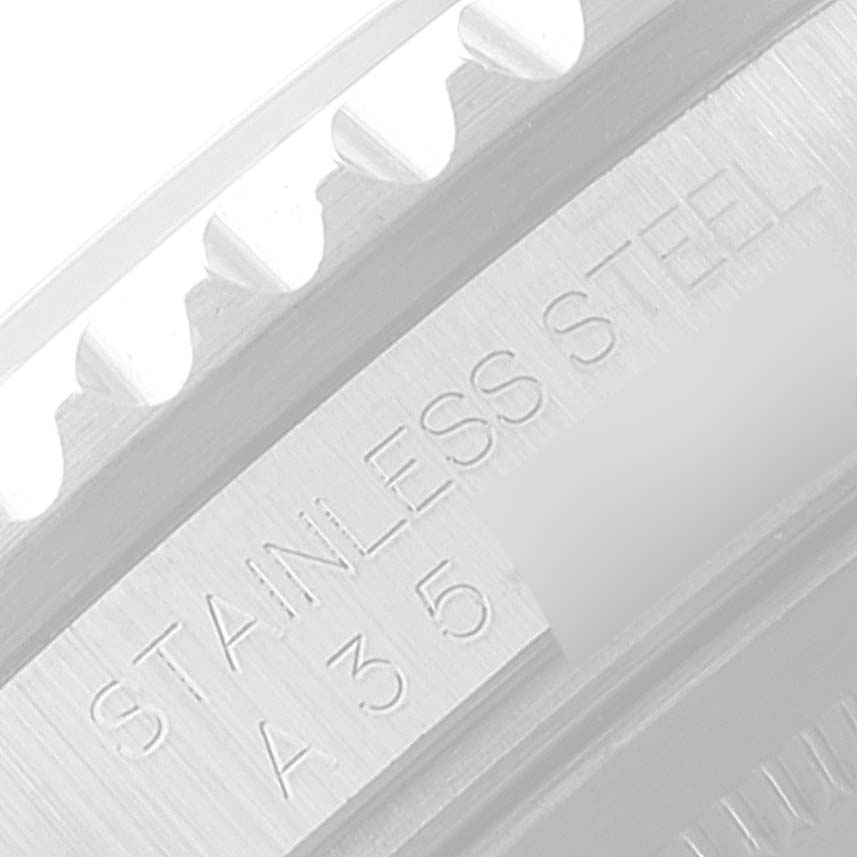 This is a close-up angle showing the "STAINLESS STEEL" engraving on the casing of a Rolex GMT-Master 16710 Men's Stainless Steel Black Dial 16710 Men's Stainless Steel Black Dial watch.