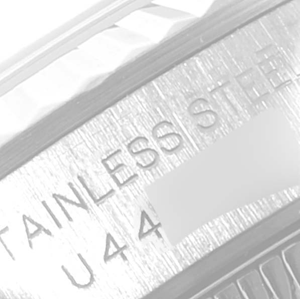 The image shows a close-up of the stainless steel part of a Rolex Oyster Perpetual 67194 Women
s Stainless Steel Silver Dial 67194 Women
s Stainless Steel Silver Dial watch, specifically the case back with some serial markings.