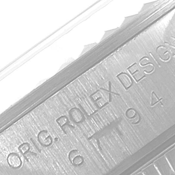 This image shows a close-up of the engraved side of a Rolex Oyster Perpetual 67194 Women
s Stainless Steel Silver Dial 67194 Women
s Stainless Steel Silver Dial watch.