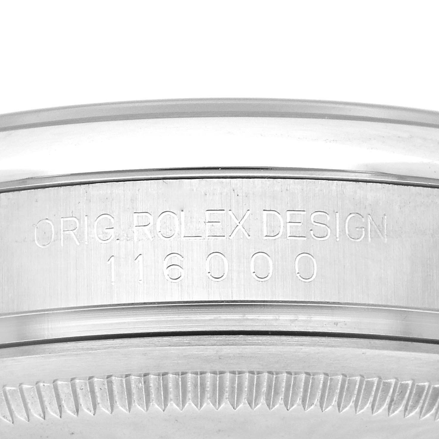 The image shows a close-up side view of the bezel and case of a Rolex Oyster Perpetual 116000 Men's Stainless Steel Champagne Dial 116000 Men's Stainless Steel Champagne Dial watch, displaying the engraved model number.