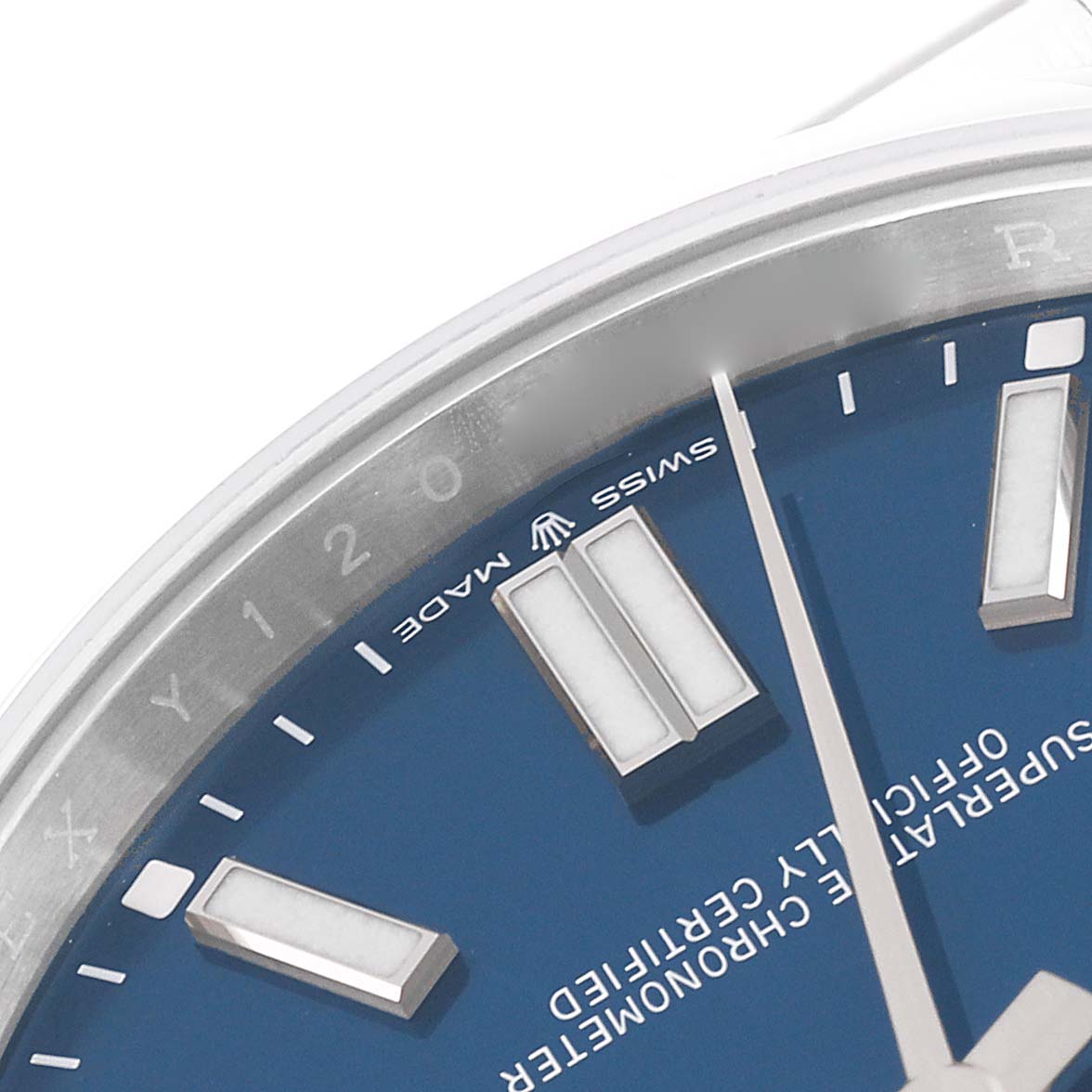 This image shows a close-up of the dial and bezel of a Rolex Oyster Perpetual 124300 Men
s Stainless Steel Blue Dial 124300 Men
s Stainless Steel Blue Dial watch, highlighting the markers and "Swiss Made" text.