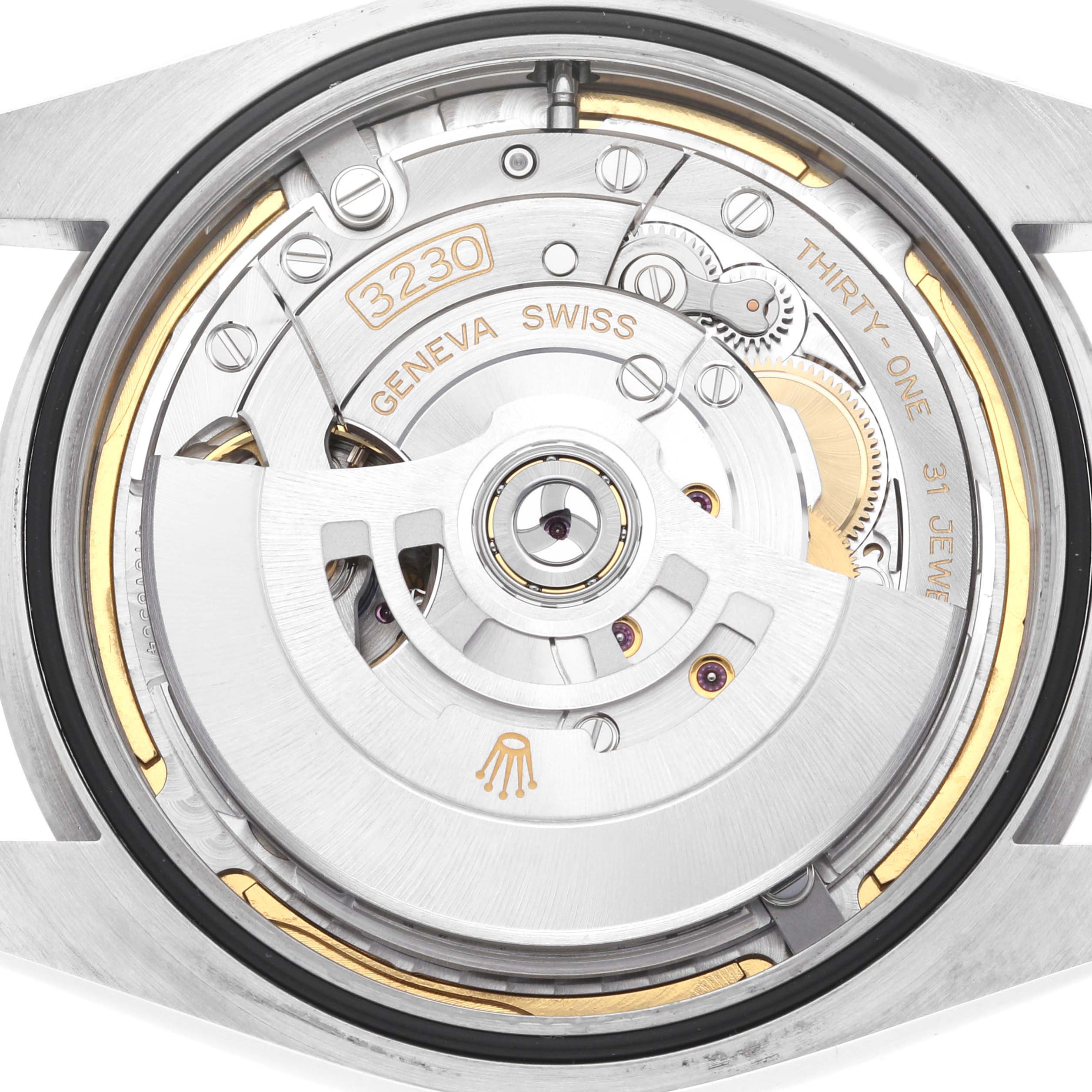 This image shows the intricate inner mechanism of a Rolex Oyster Perpetual 124300 Men
s Stainless Steel Blue Dial 124300 Men
s Stainless Steel Blue Dial watch, focusing on the movement and gears.