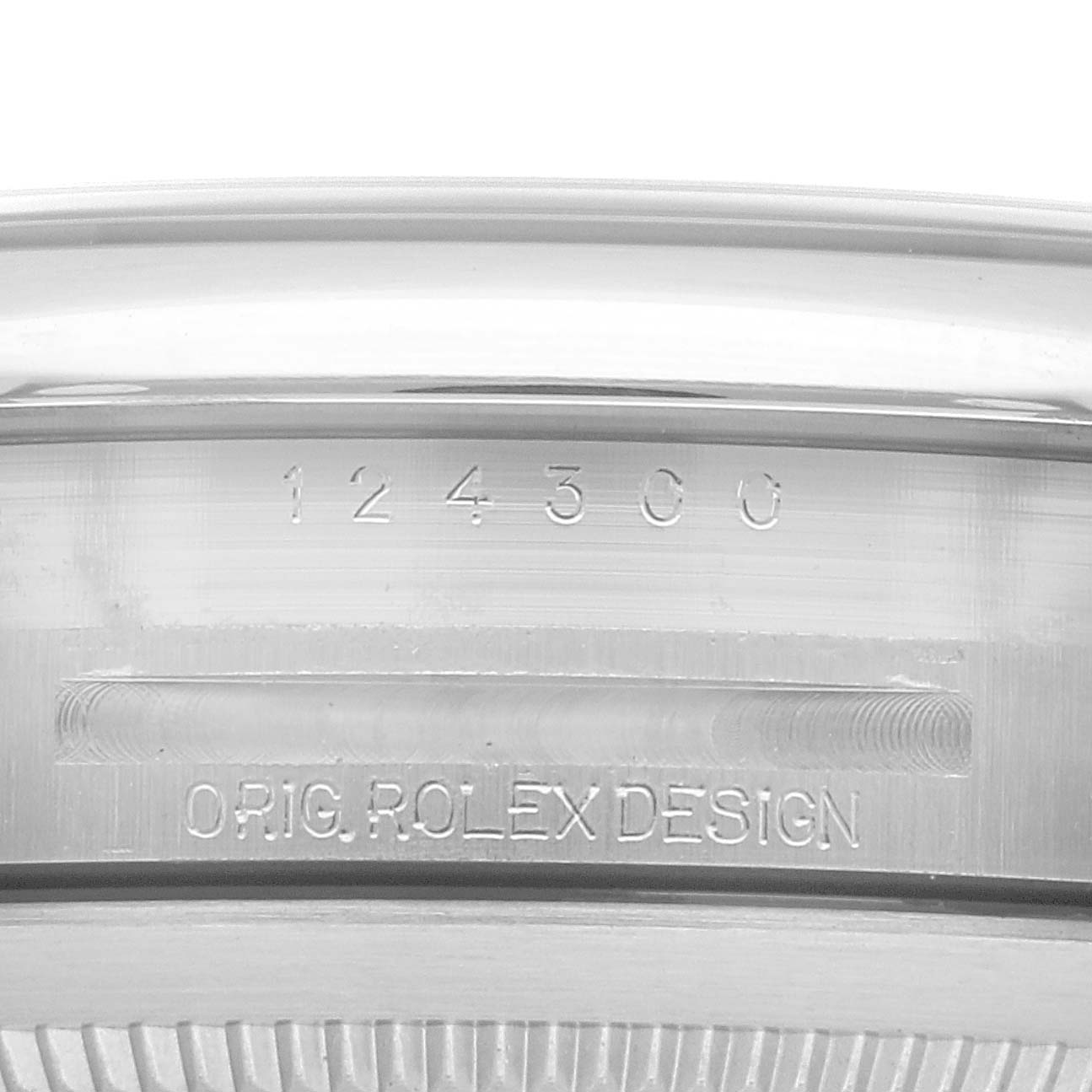 This image shows a close-up of the case back edge with serial and design engravings of an Oyster Perpetual Rolex watch.