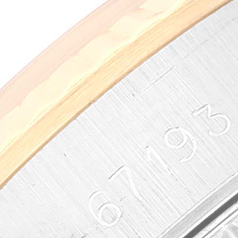 Close-up of the bezel edge and case side with engraved serial number of a Rolex Oyster Perpetual 67193 Women's Steel and Gold (two tone) Blue Dial 67193 Women's Steel and Gold (two tone) Blue Dial watch.