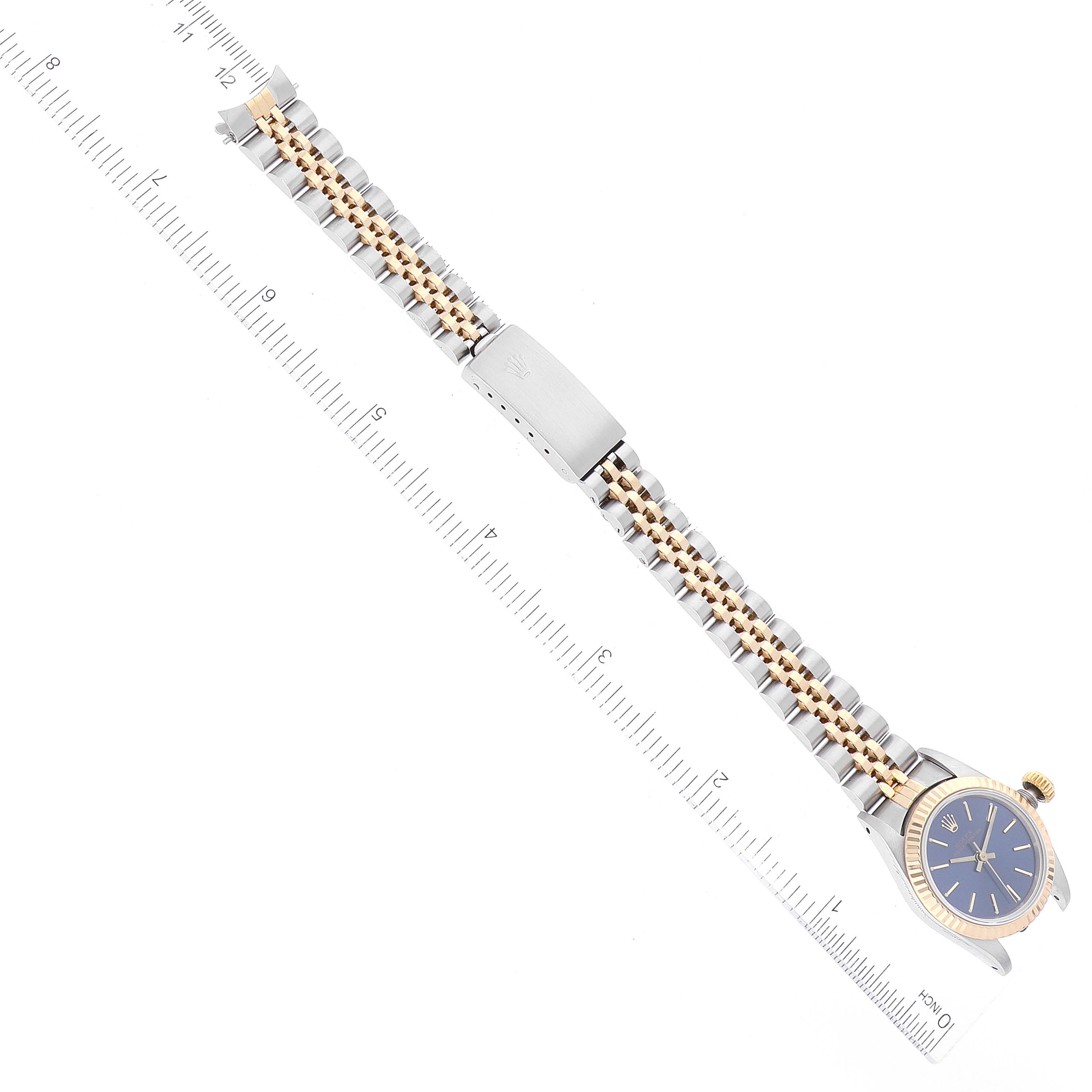 The image shows a top-down view of a Rolex Oyster Perpetual 67193 Women's Steel and Gold (two tone) Blue Dial 67193 Women's Steel and Gold (two tone) Blue Dial watch, highlighting its bracelet and clasp.