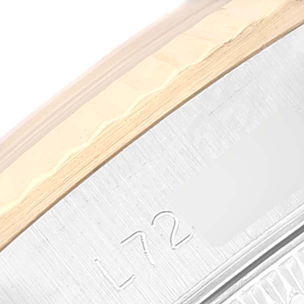 This close-up image shows the side of the bezel and serial number area of the Rolex Oyster Perpetual 67193 Women's Steel and Gold (two tone) Blue Dial 67193 Women's Steel and Gold (two tone) Blue Dial watch.