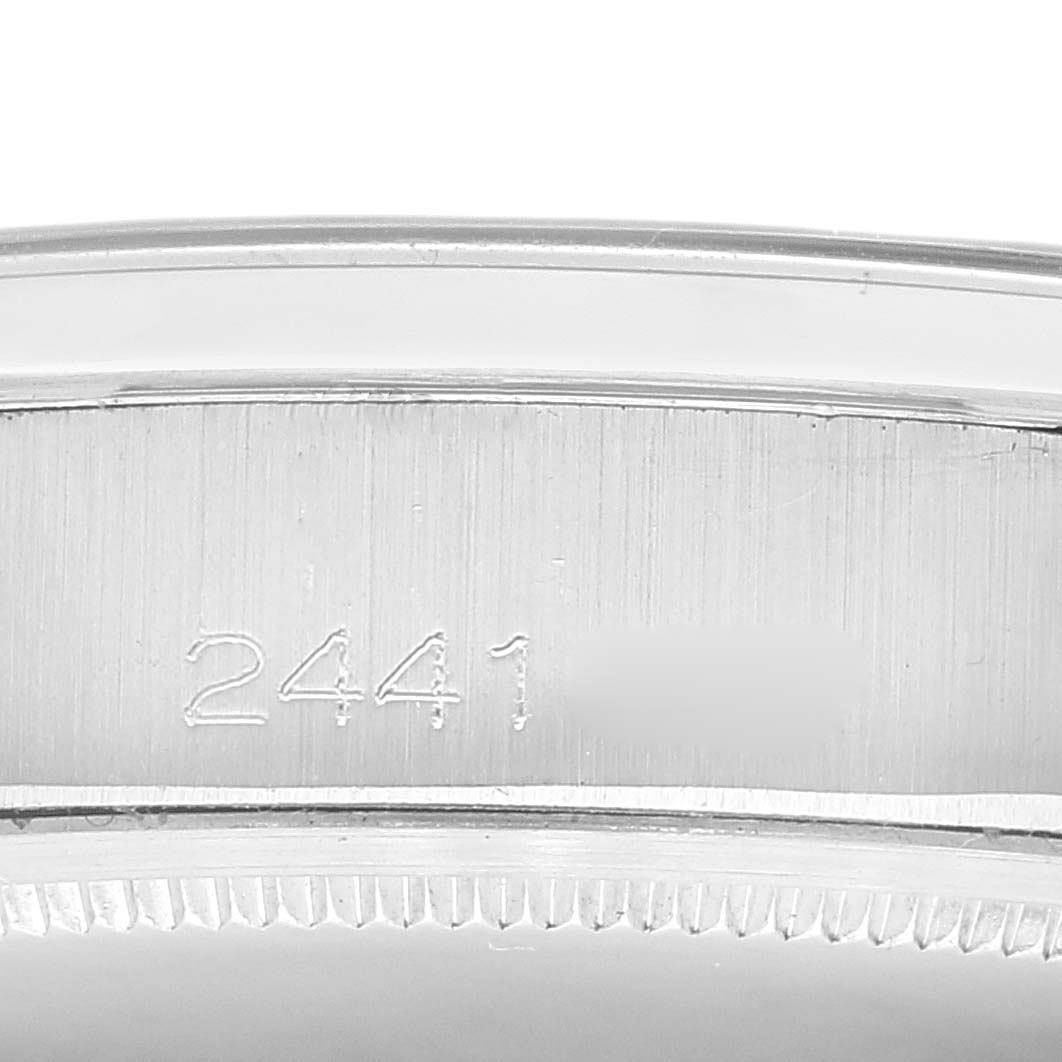 The image shows the side of a Rolex Vintage Collection 6694 Men's Stainless Steel Silver Dial 6694 Men's Stainless Steel Silver Dial watch, focusing on the serial number engraving.