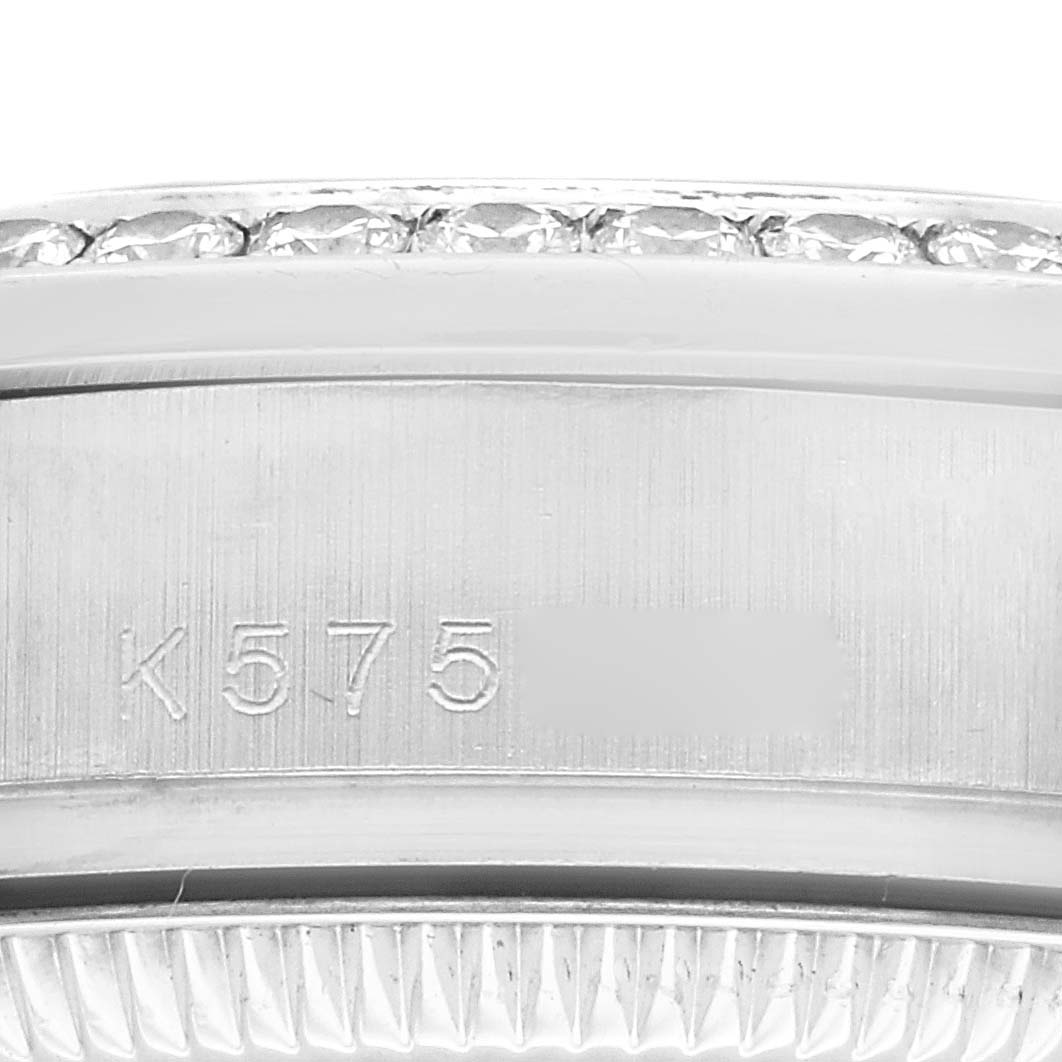 This close-up image shows a partial view of a Rolex President 178286 Women's Platinum Blue Dial 178286 Women's Platinum Blue Dial model watch case, featuring serial engraving and part of the bezel.