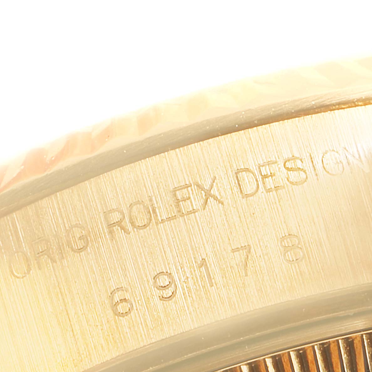 This image shows a close-up angle of the side of a Rolex President 69178 Women
s Yellow Gold Champagne Dial 69178 Women
s Yellow Gold Champagne Dial model watch, highlighting the engravings.