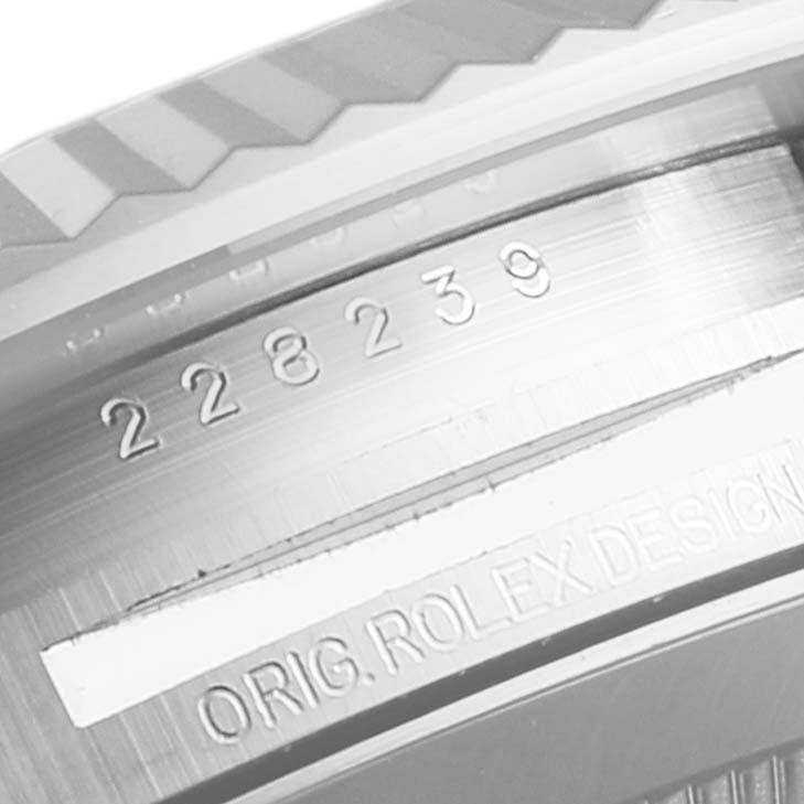 The image shows a close-up of the engraving on the inner bezel of a Rolex President 228239 Men's White Gold Blue Dial 228239 Men's White Gold Blue Dial model watch.