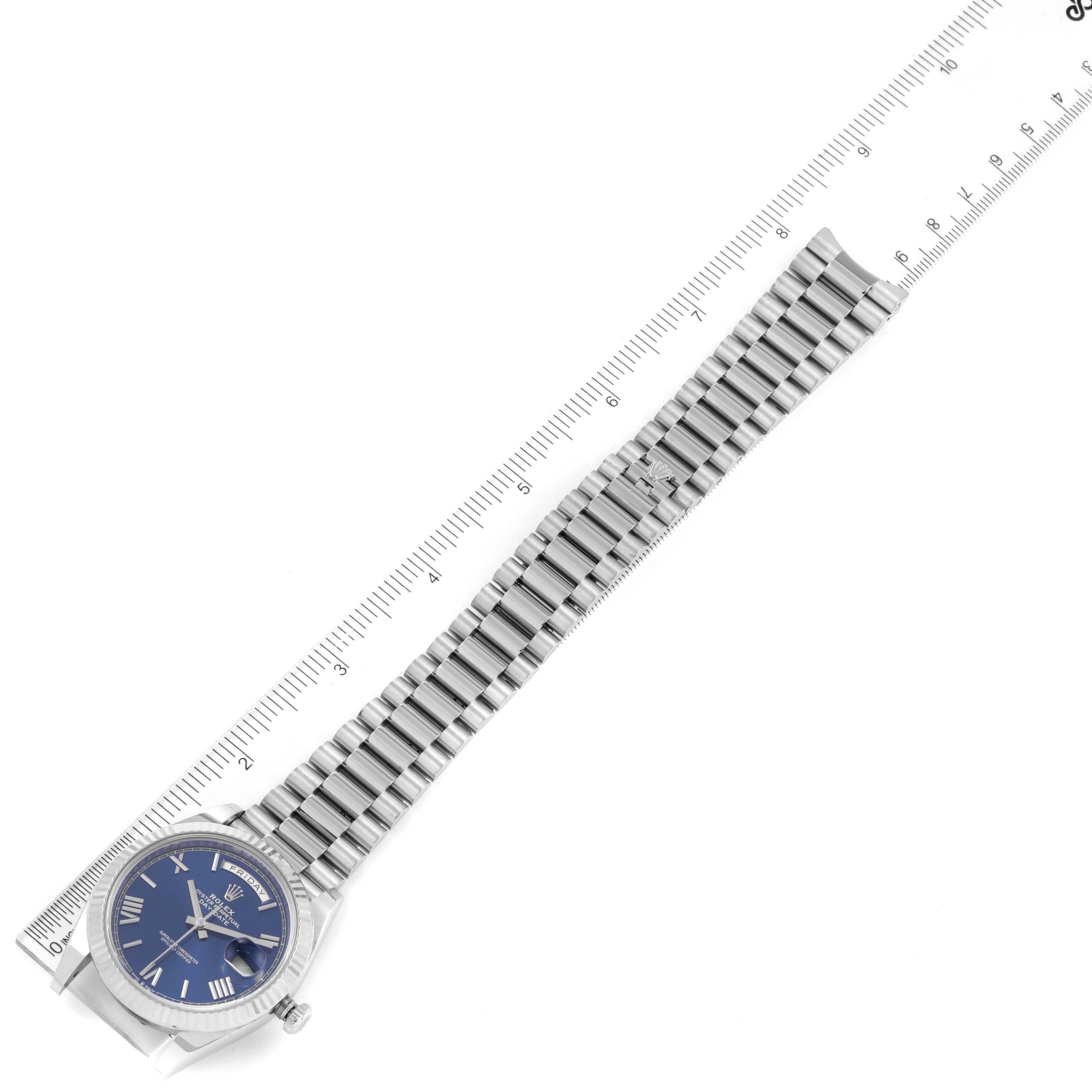 The image shows a Rolex President 228239 Men's White Gold Blue Dial 228239 Men's White Gold Blue Dial model watch laid flat with the face and full length of the bracelet visible against a ruler.
