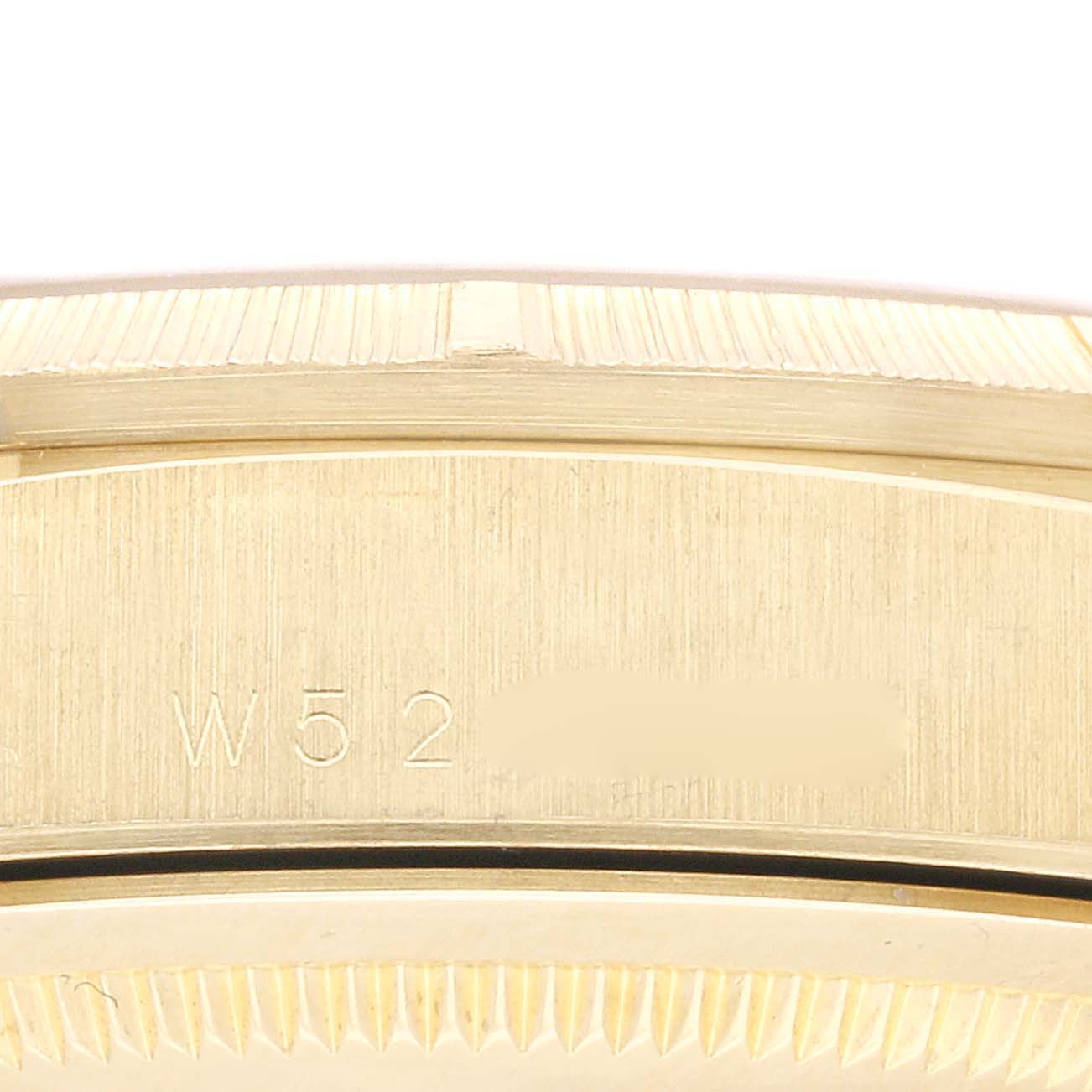 This close-up image shows the side of the case of a Rolex President 18248 Men
s Yellow Gold Champagne Dial 18248 Men
s Yellow Gold Champagne Dial model, highlighting the serial number engraving.