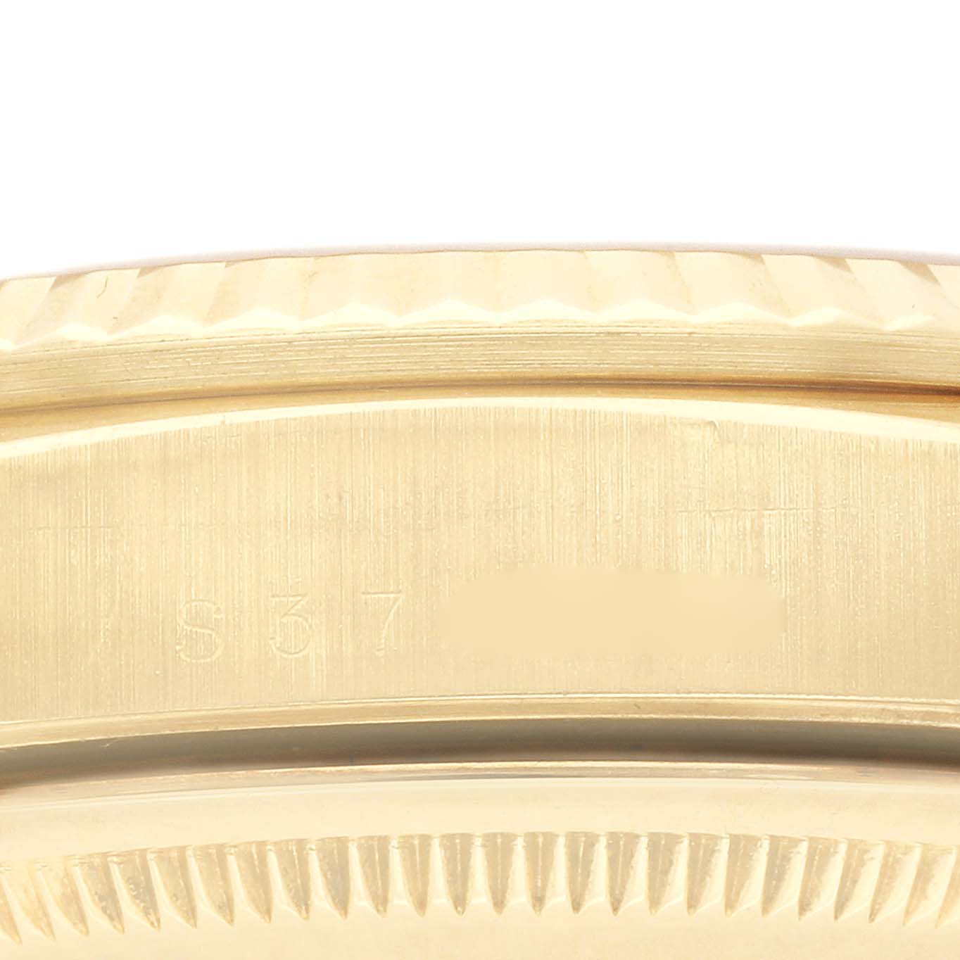 This image shows a close-up of the fluted bezel and edge of the case with engraving on the Rolex President 18238 Men
s Yellow Gold Champagne Dial 18238 Men
s Yellow Gold Champagne Dial watch.