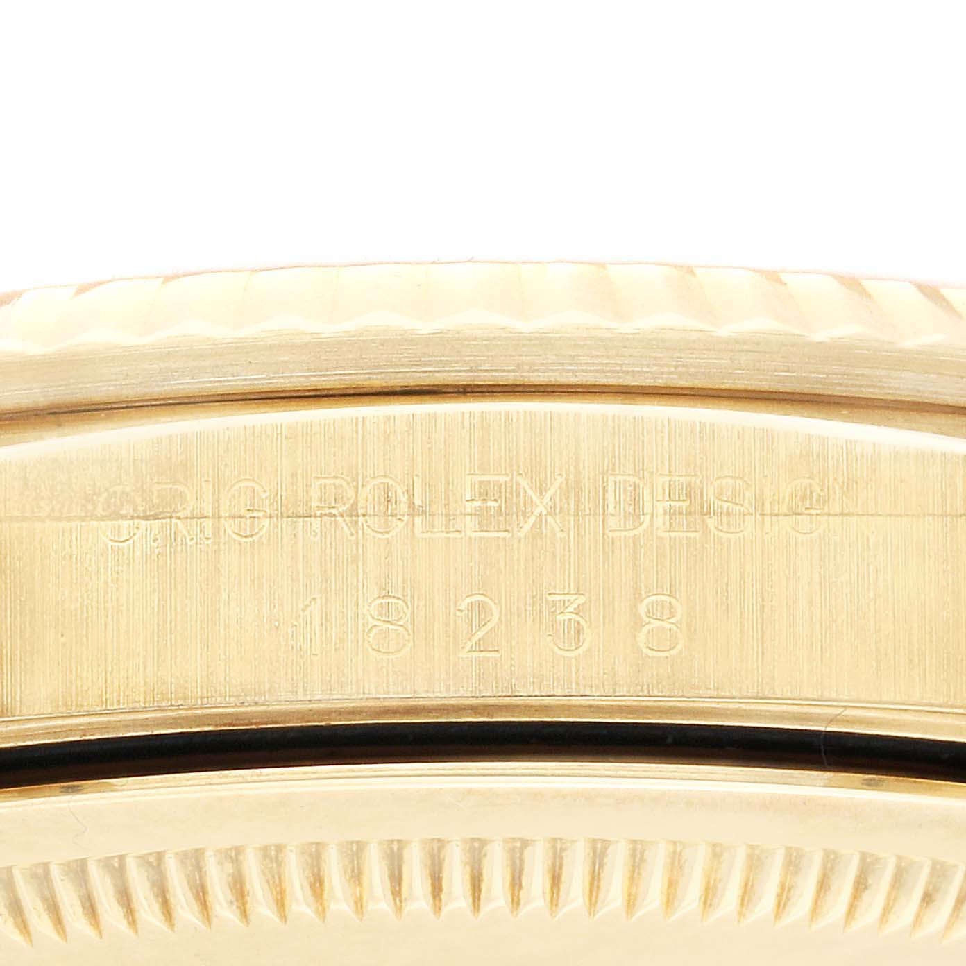 Close-up of the side of a Rolex President 18238 Men
s Yellow Gold Champagne Dial 18238 Men
s Yellow Gold Champagne Dial model, showing the model number and part of the fluted bezel.