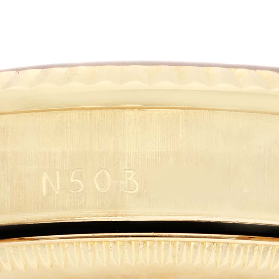 This close-up image shows the side of a Rolex President 68278G Women's Yellow Gold Black Dial 68278G Women's Yellow Gold Black Dial model watch, highlighting its engraving and part of the bezel and case.