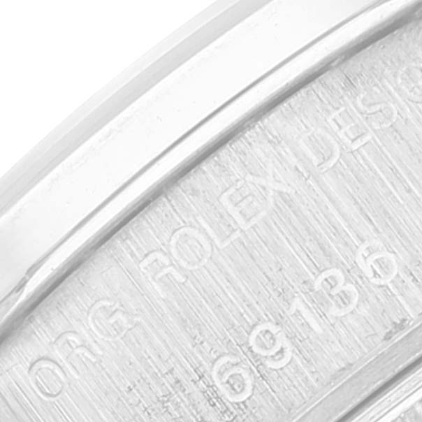 The image shows a close-up view of the inner bezel of the Rolex President 69136 Women's Platinum Silver Dial 69136 Women's Platinum Silver Dial watch, displaying engravings.