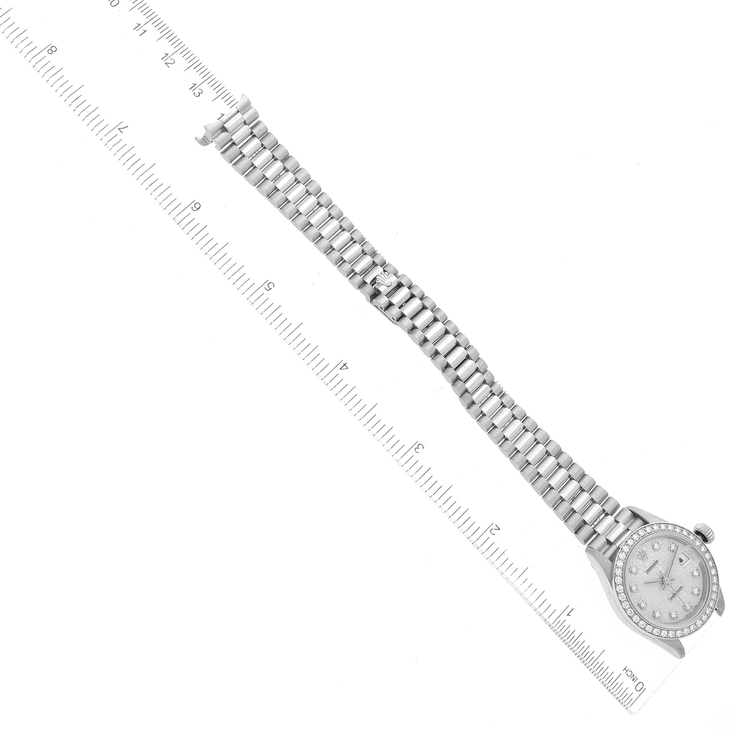 The image shows a Rolex President 69136 Women's Platinum Silver Dial 69136 Women's Platinum Silver Dial model watch laid flat, with its band and face visible, alongside a measuring ruler.