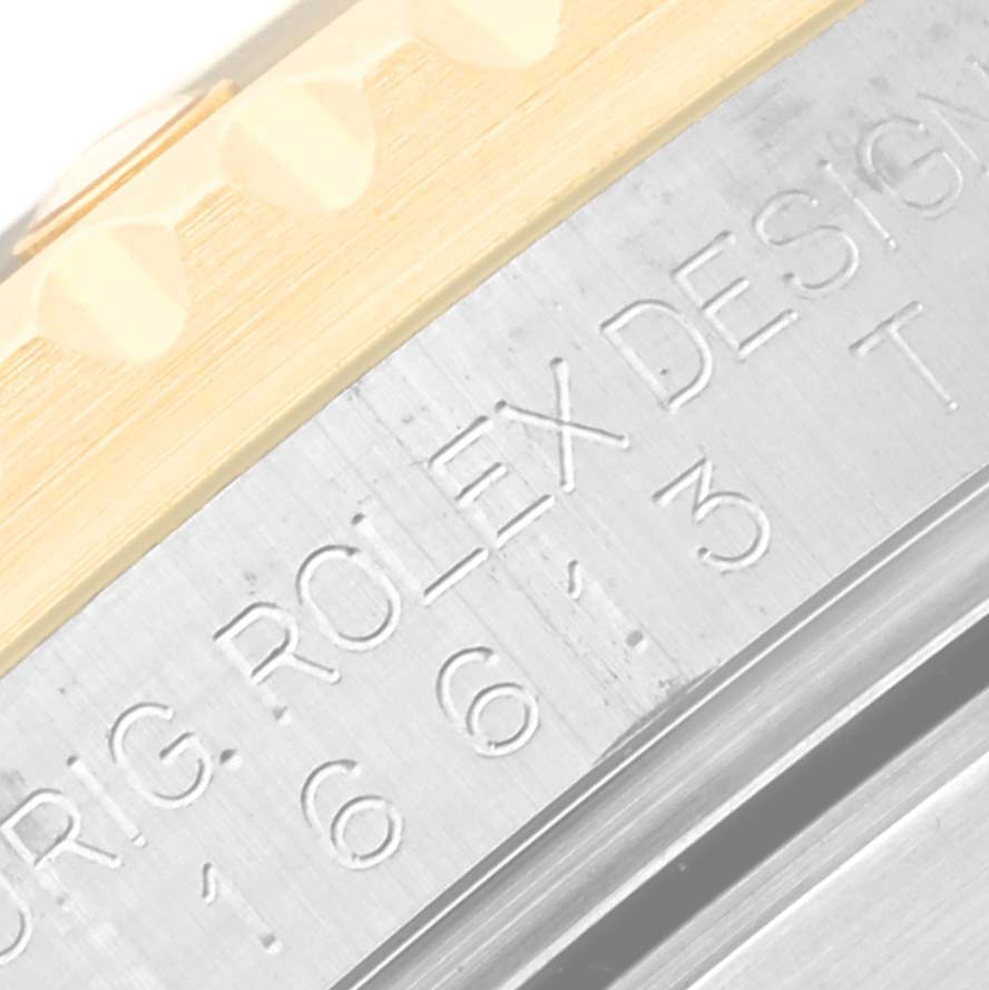 Close-up of the Submariner Rolex watch showing part of the bezel and the engraved model number.