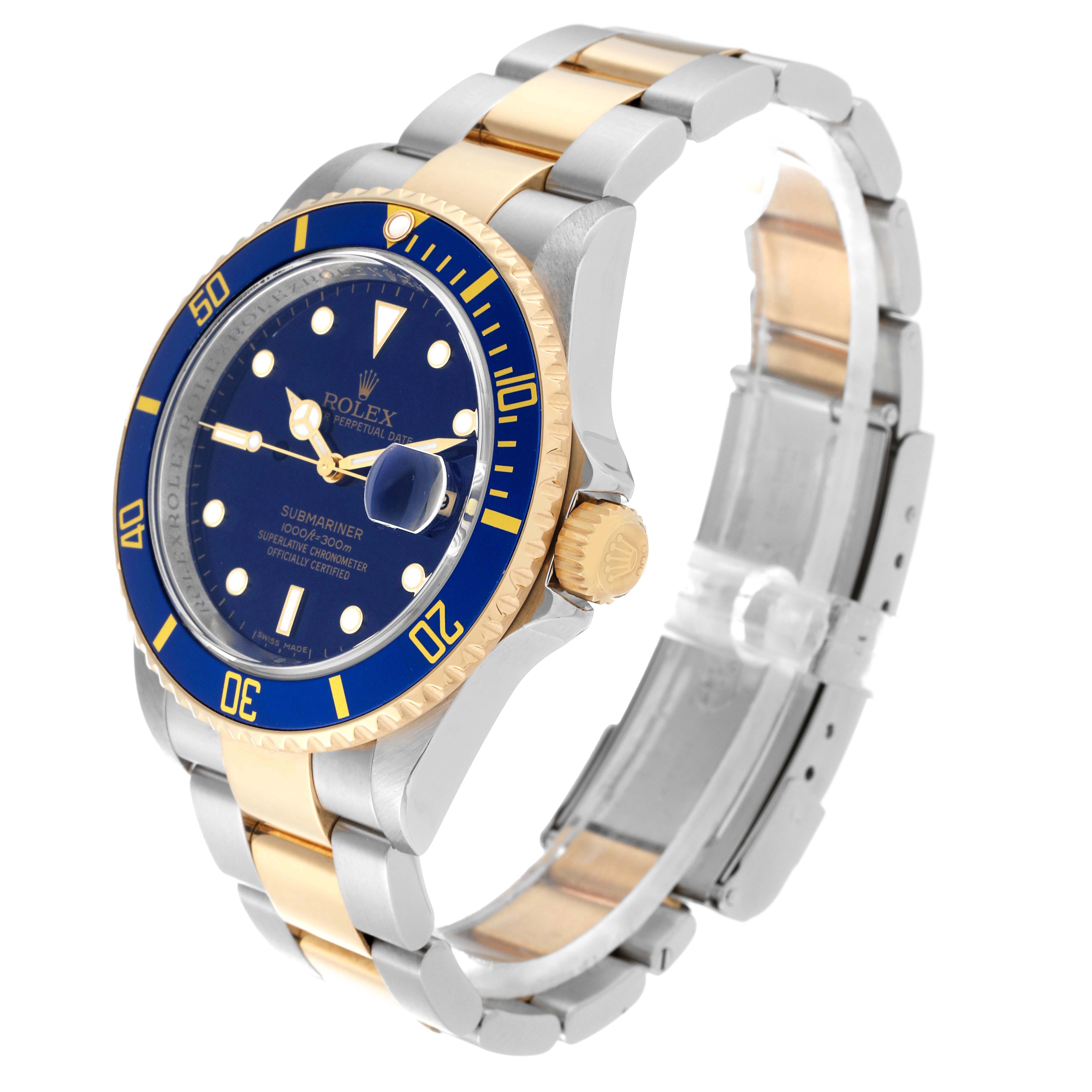 The image shows a Rolex Submariner 16613 Men's Steel and Gold (two tone) Blue Dial 16613 Men's Steel and Gold (two tone) Blue Dial watch at an oblique angle, highlighting the blue and gold bezel, dial, and two-tone bracelet.