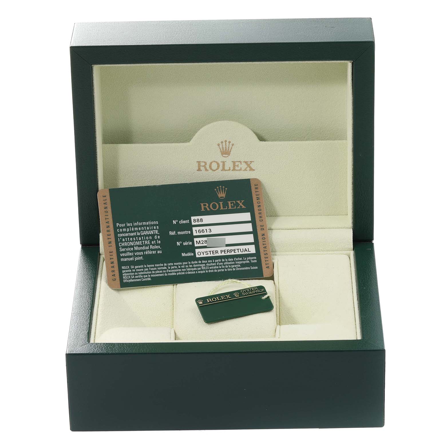 The image shows an open green Rolex box for the Submariner model, containing a certification card and a tag.