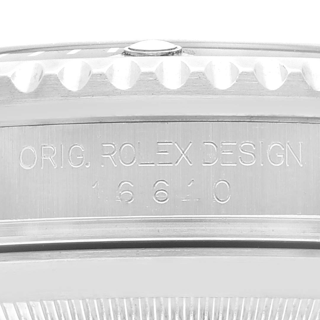 The image shows the side view of a Rolex Submariner 16610 Men
s Stainless Steel Black Dial 16610 Men
s Stainless Steel Black Dial model 16610, highlighting the engraved "ORIG. ROLEX DESIGN" and model number.