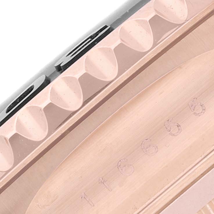 This image shows a close-up view of the side of a Rolex Yacht-Master 116655 Men's Rose Gold Black Dial 116655 Men's Rose Gold Black Dial watch, focusing on its bezel and engraved case.