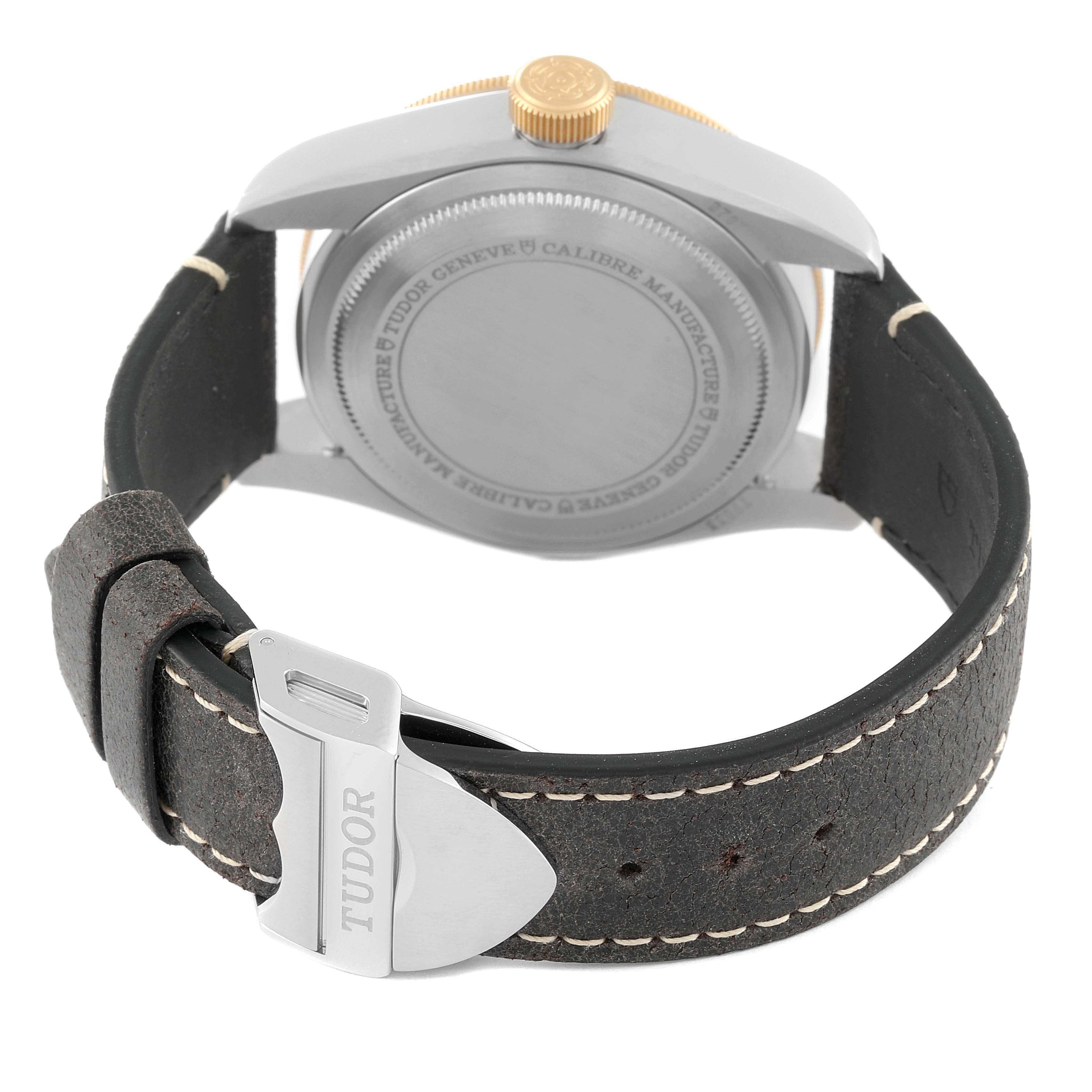 The image shows the back view of a Tudor Heritage Black Bay 79833MN Men's Stainless Steel Black Dial 79833MN Men's Stainless Steel Black Dial watch, including the case back, crown, and leather strap with a buckle.