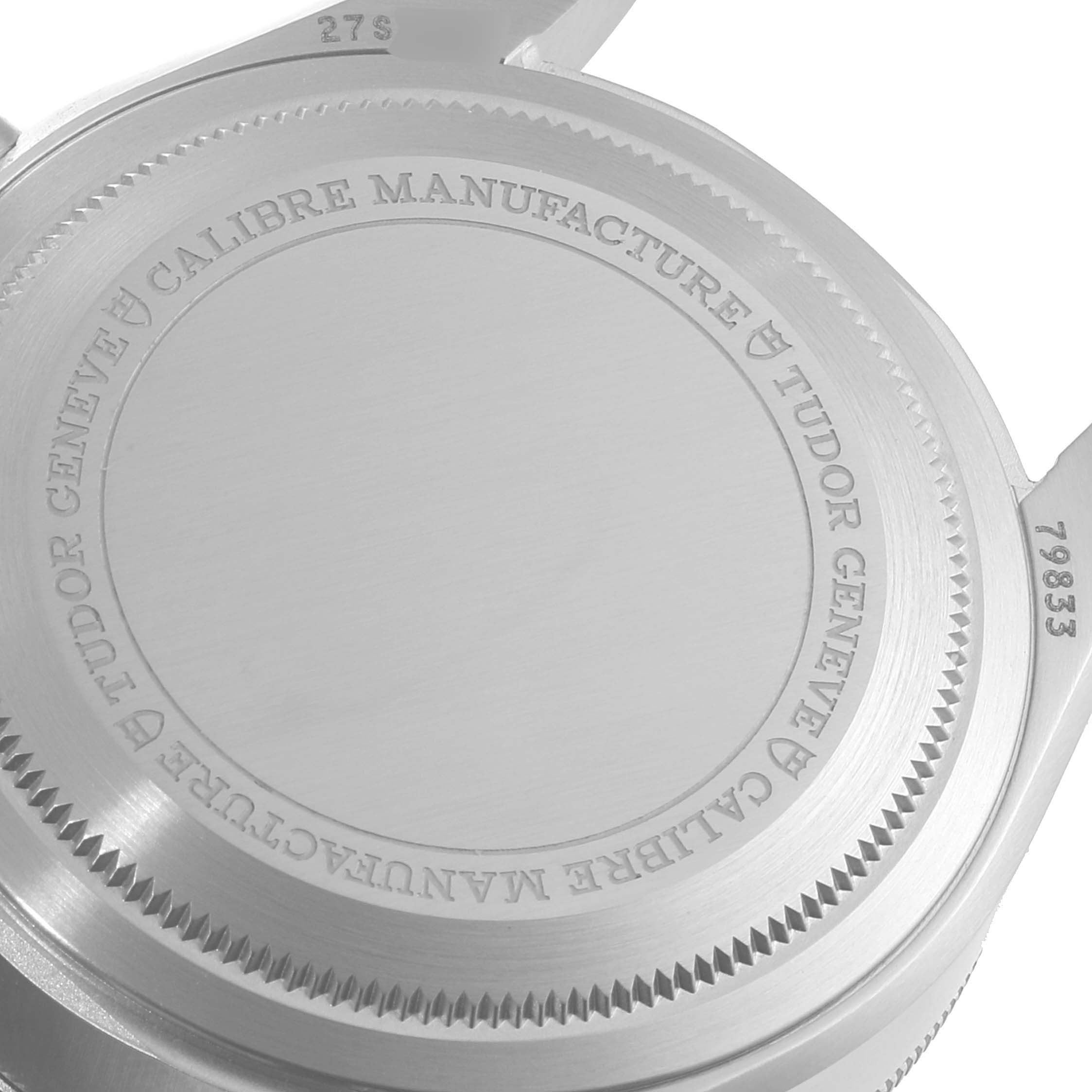 This image shows the back case of a Tudor Heritage Black Bay 79833MN Men's Stainless Steel Black Dial 79833MN Men's Stainless Steel Black Dial watch with engraved details and serial numbers.